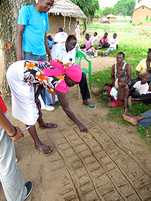 Volunteers and community members in Katakwi practicing the seasonal calendar tool