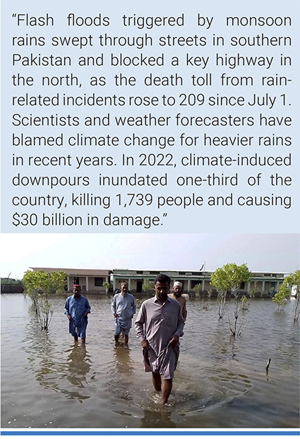 Villagers wade through flood areas caused by heavy monsoon rains near Sohbat Pur, an area of Pakistan's southwestern Baluchistan province. Photo: AP.