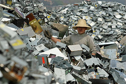 ewaste-worker-on-a-mountain-of-e-waste