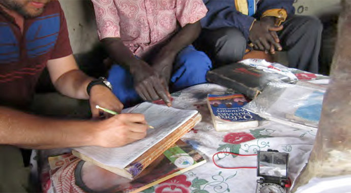 Red Cross/Red Crescent intern, Drew Zackary, working with community members in Uganda.