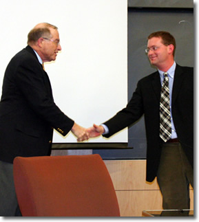 Dr. Lane shaking hands with Dr. Pielke